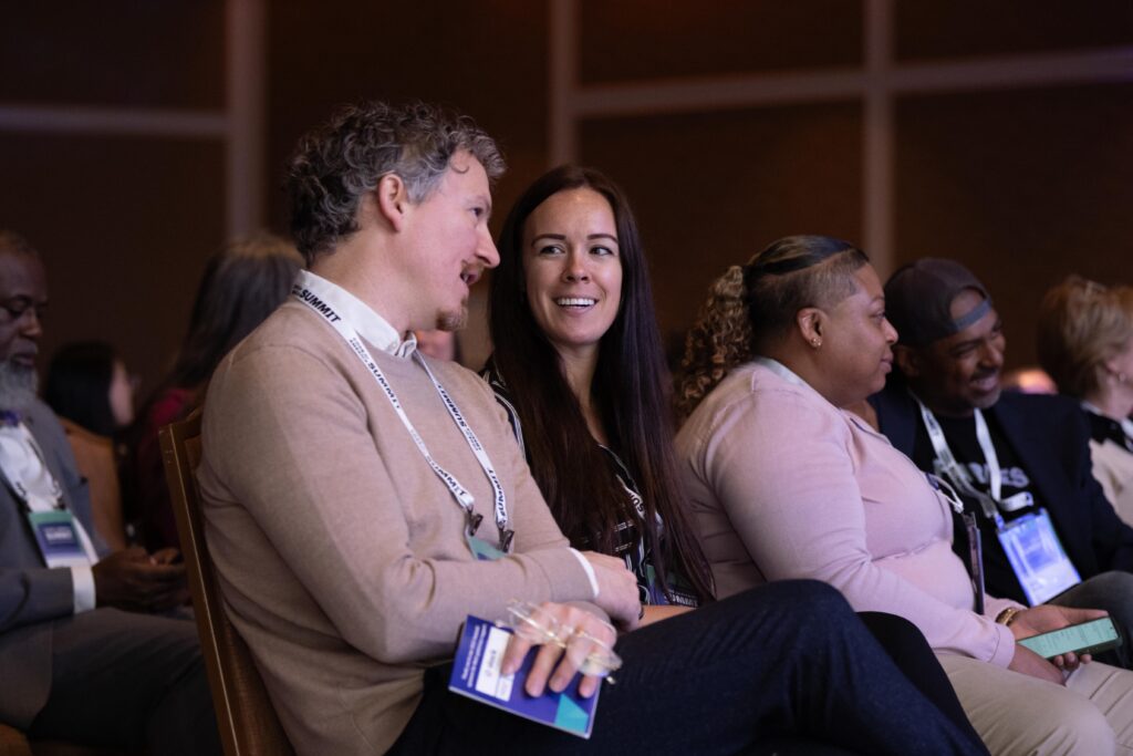 Code for America Summit attendees seated, smiling, having a conversation