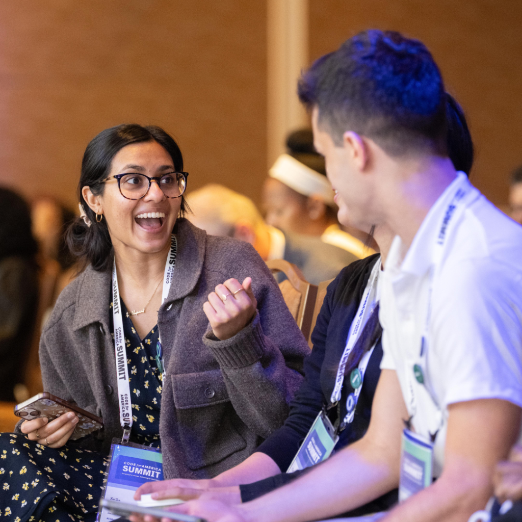 Two Code for America Summit attendees having a lively conversation
