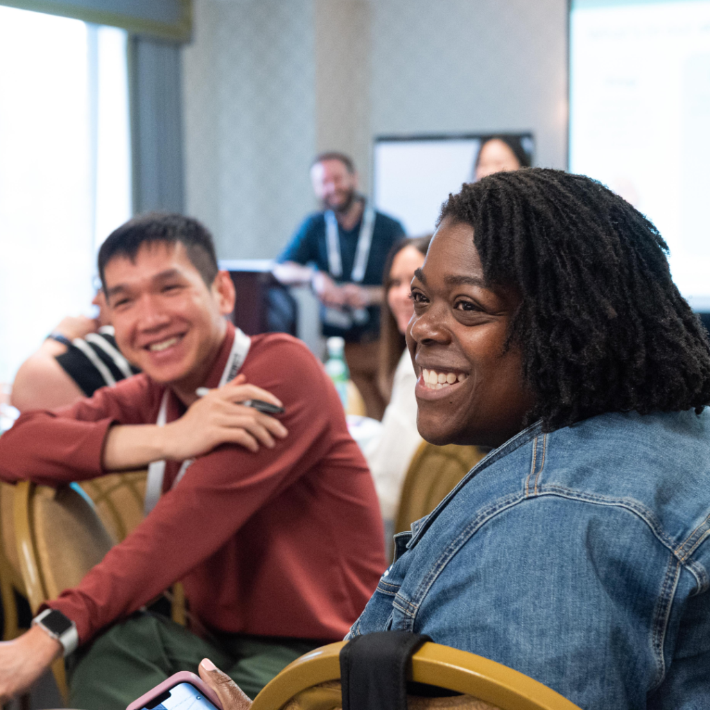 Attendees smiling at a breakout session at Code for America Summit